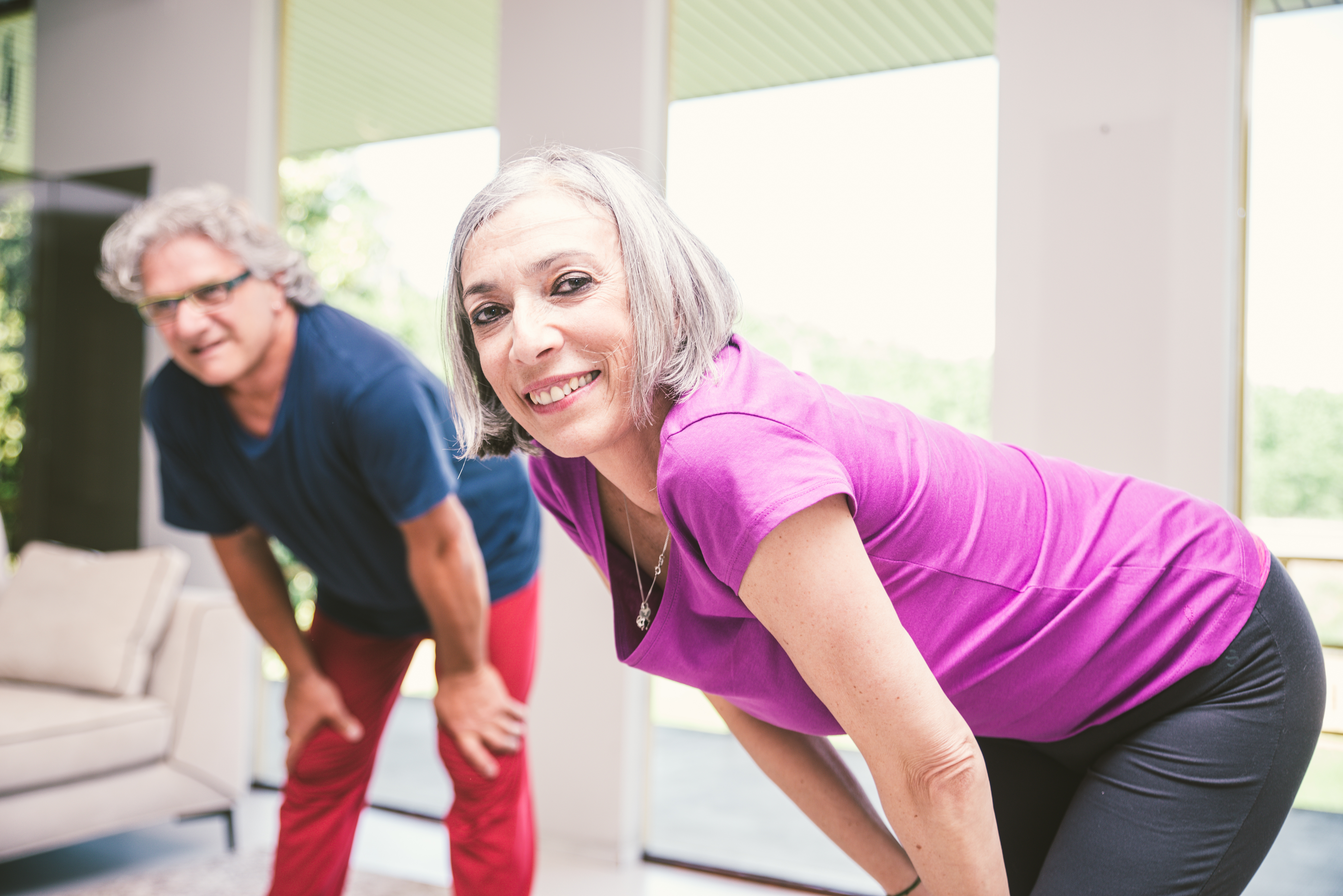 Two people stretching indoors