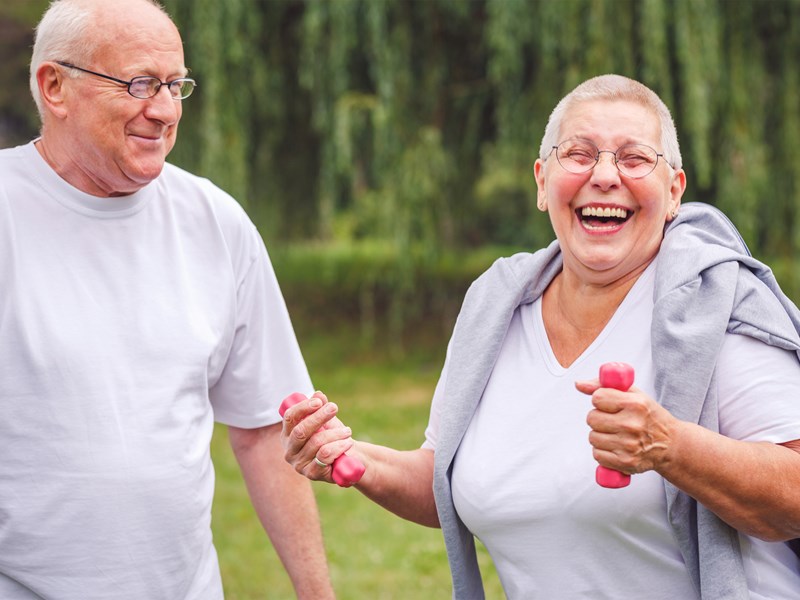 Older and woman exercising outdoors