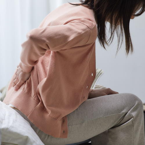 Person holding their back