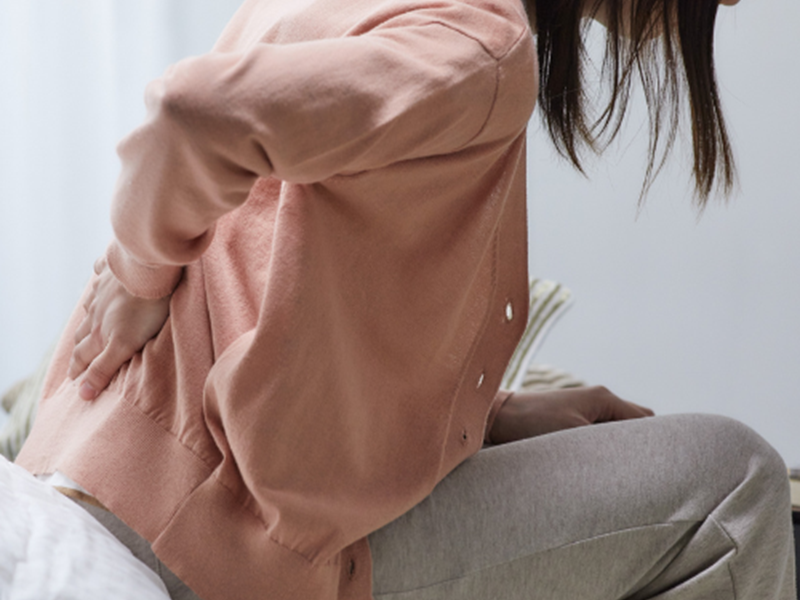 Person holding their back